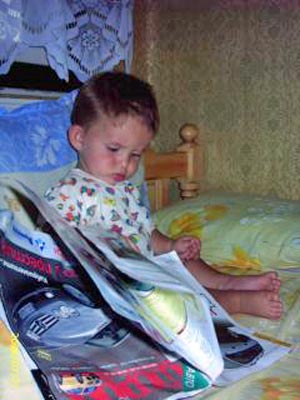 A photo of a toddler reading.