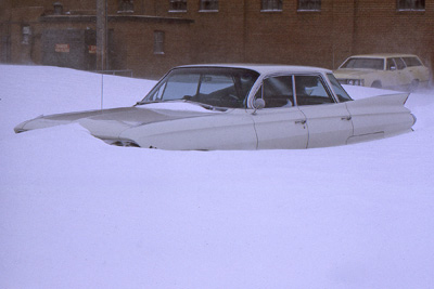 A photo of a Cadillac buried in the snow.