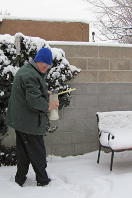 A photo of Morris measuring snow.