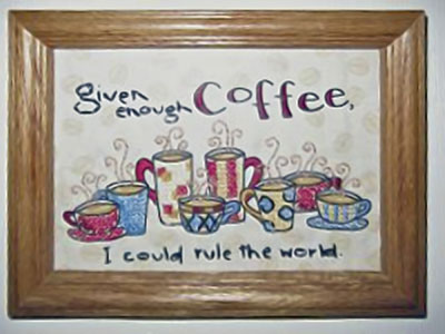A photo of a cross-stich that says, 'Given enough coffee, I cold rule the world.'
