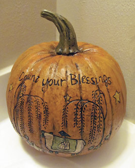 A photographic image of a holiday pumpkin with the words, 'Count your Blessings', written on it.