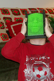 The last photo from our 2008 album where Aiden presses his face into his present.