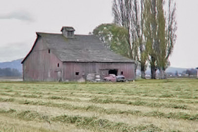 A photographic image of an old barn.