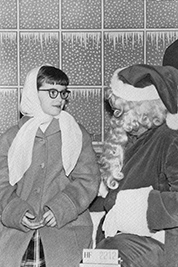 A photographic image of Mary Hunt on Santa's lap.