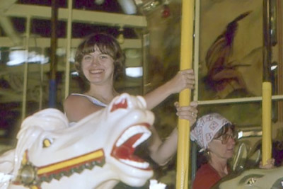 A photographic image of Mary Hunt Webb on a carousel.