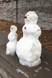 A photographic image from December 2011 of a snow mother and her child.