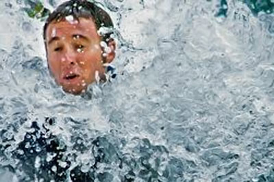 A photographic image of a man in turbulent waters.