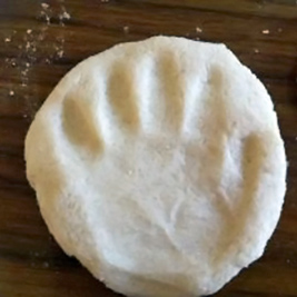 A photographic image of a baby's handprint.