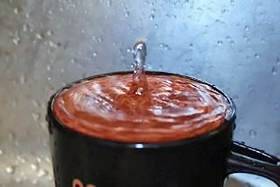 A photographic image of an overflowing mug.