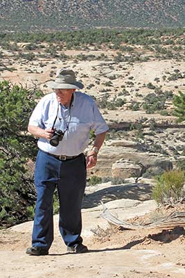 A photographic image of Morris Webb waking up a trail in Natural Bridges National Monument, Utah.