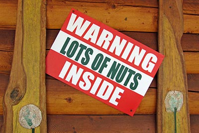 A photographic image of a sign with the caption, 'Lots of Nuts Inside'.