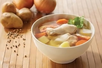 A photographic image of a bowl of Thai chicken soup.