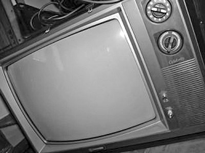 A photographic image of a vintage television set.