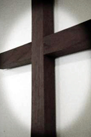 A photographic image of a spotlighted cross.