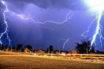 A photographic image of multiple cloud-to-ground lightning strikes