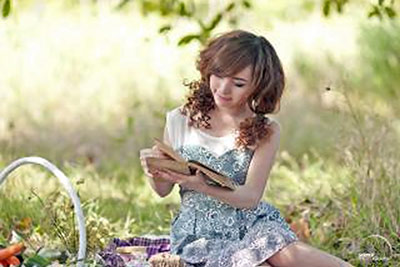 A photographic image of a girl reading a book.