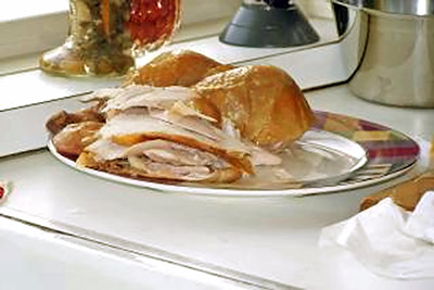 A photographic image of sliced turkey on a plate.