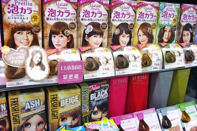 A photographic image of hair dyes on a shelf.